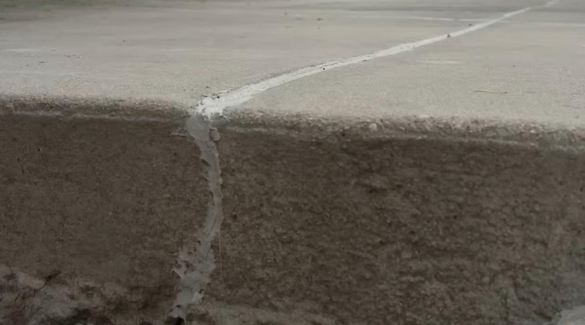 After concrete leveling - raised and flush slab with no settlement gap