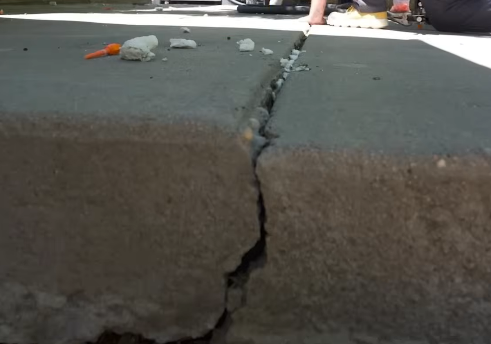 Before concrete leveling - sunken slab with visible settlement gap
