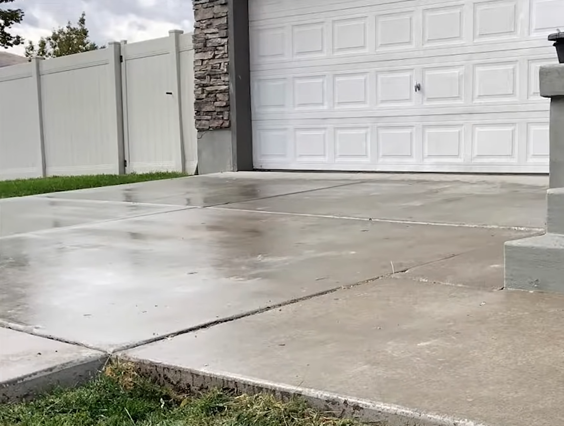 Concrete leveling crew inspecting and repairing a sunken residential slab