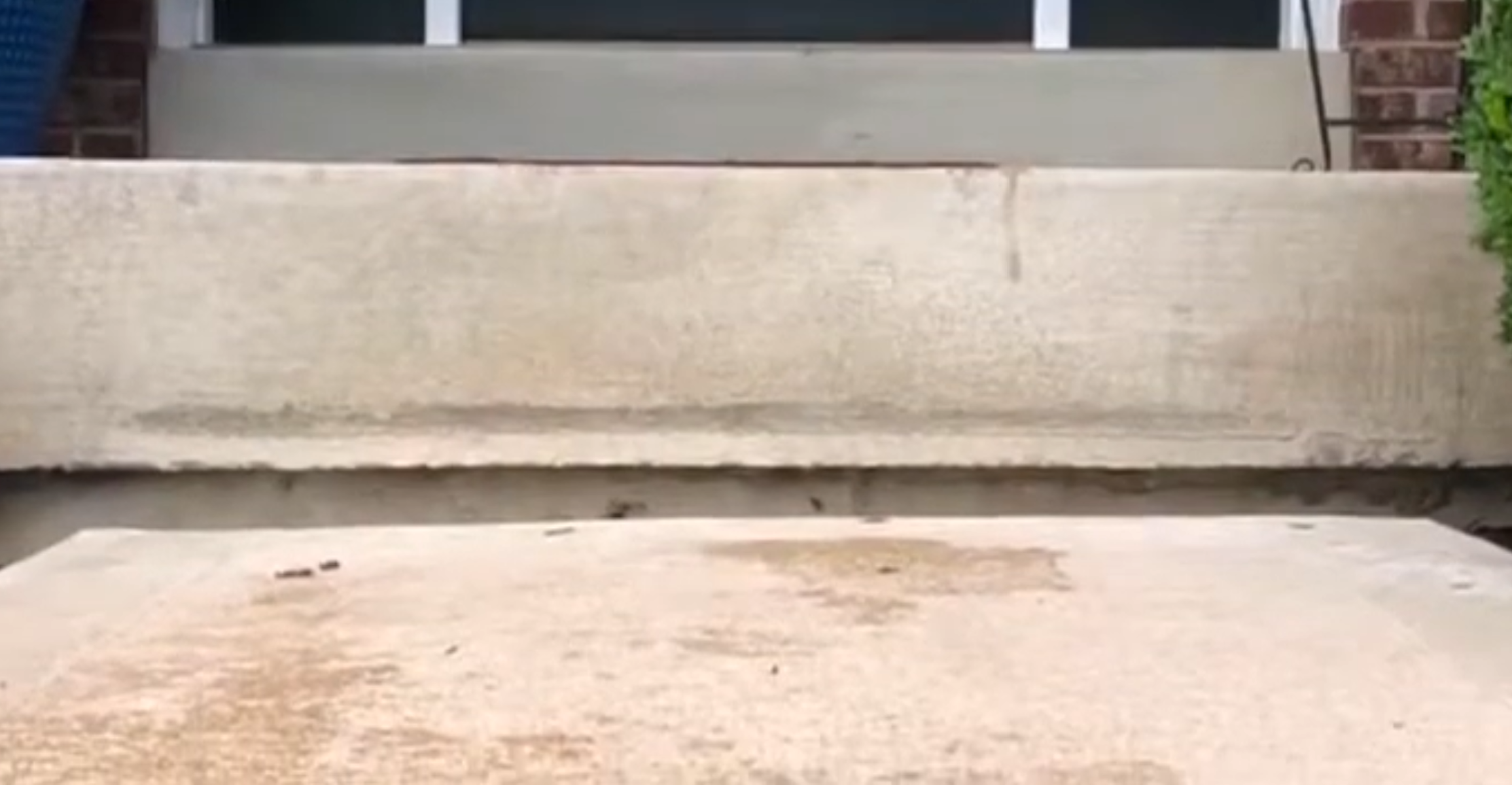 Before stoop repair - concrete front stoop sunken away from the house