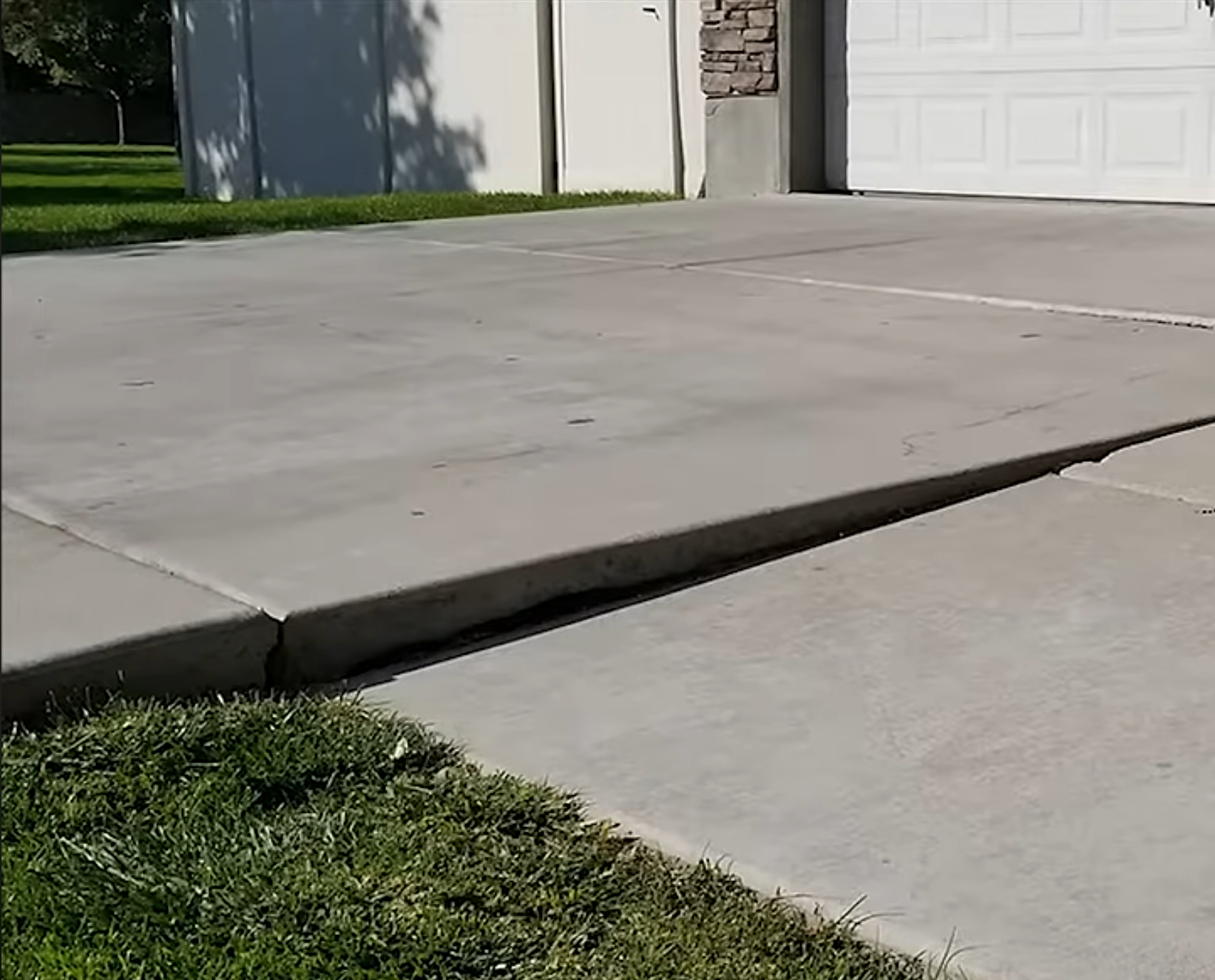 Before driveway repair - sunken concrete panel