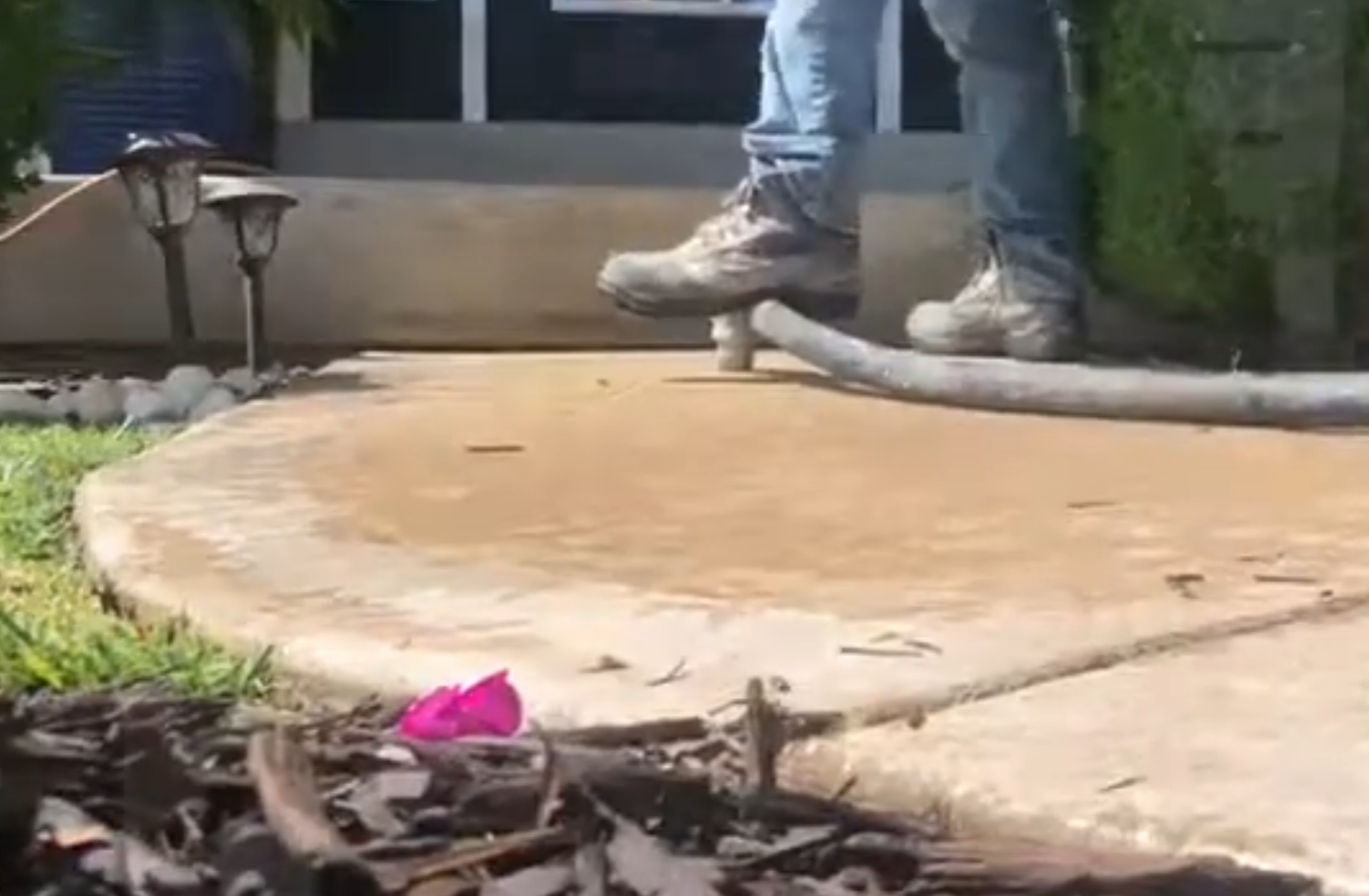 Mudjacking process showing slurry being pumped under a concrete slab