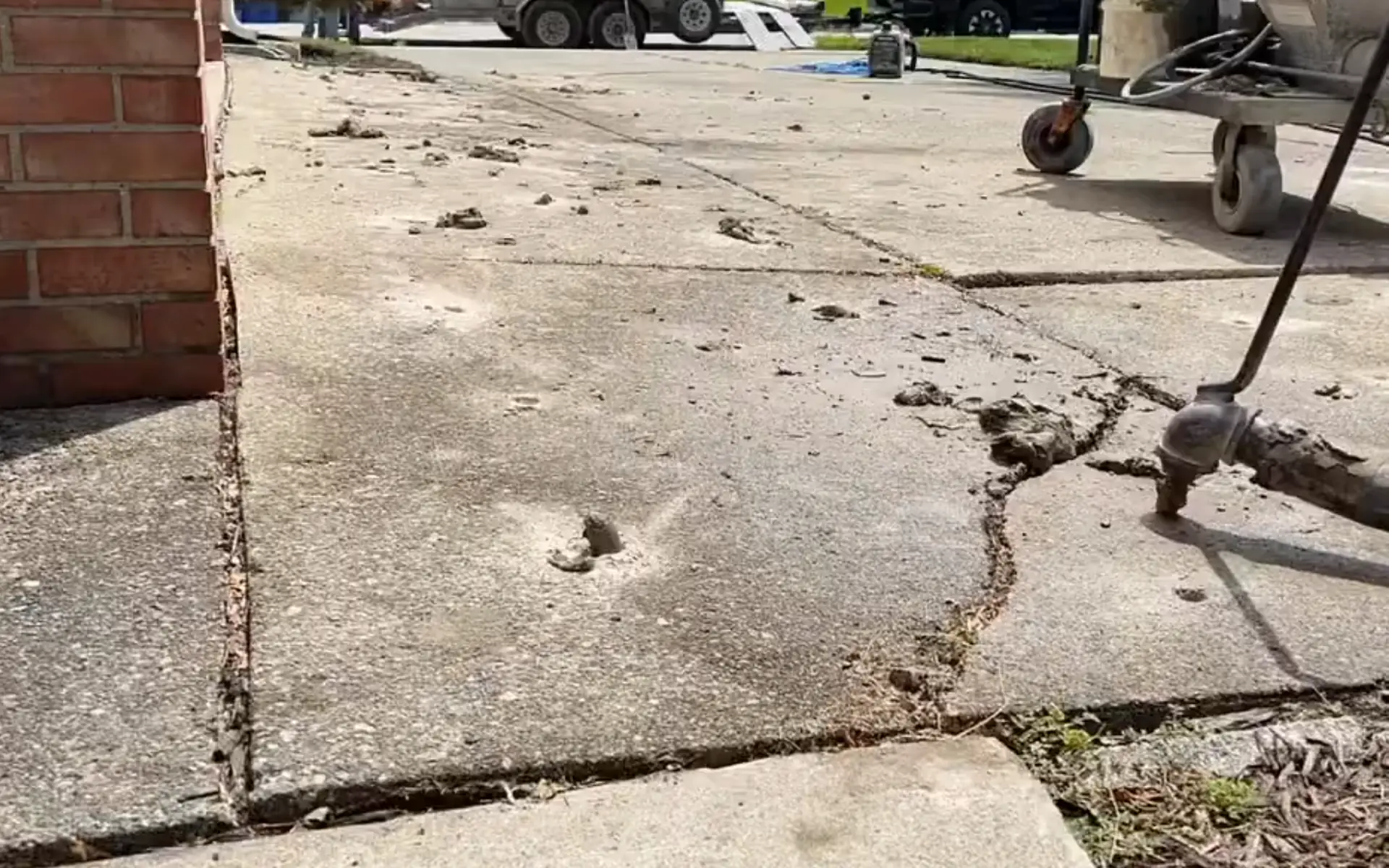 Mudjacking service lifting a sunken concrete slab