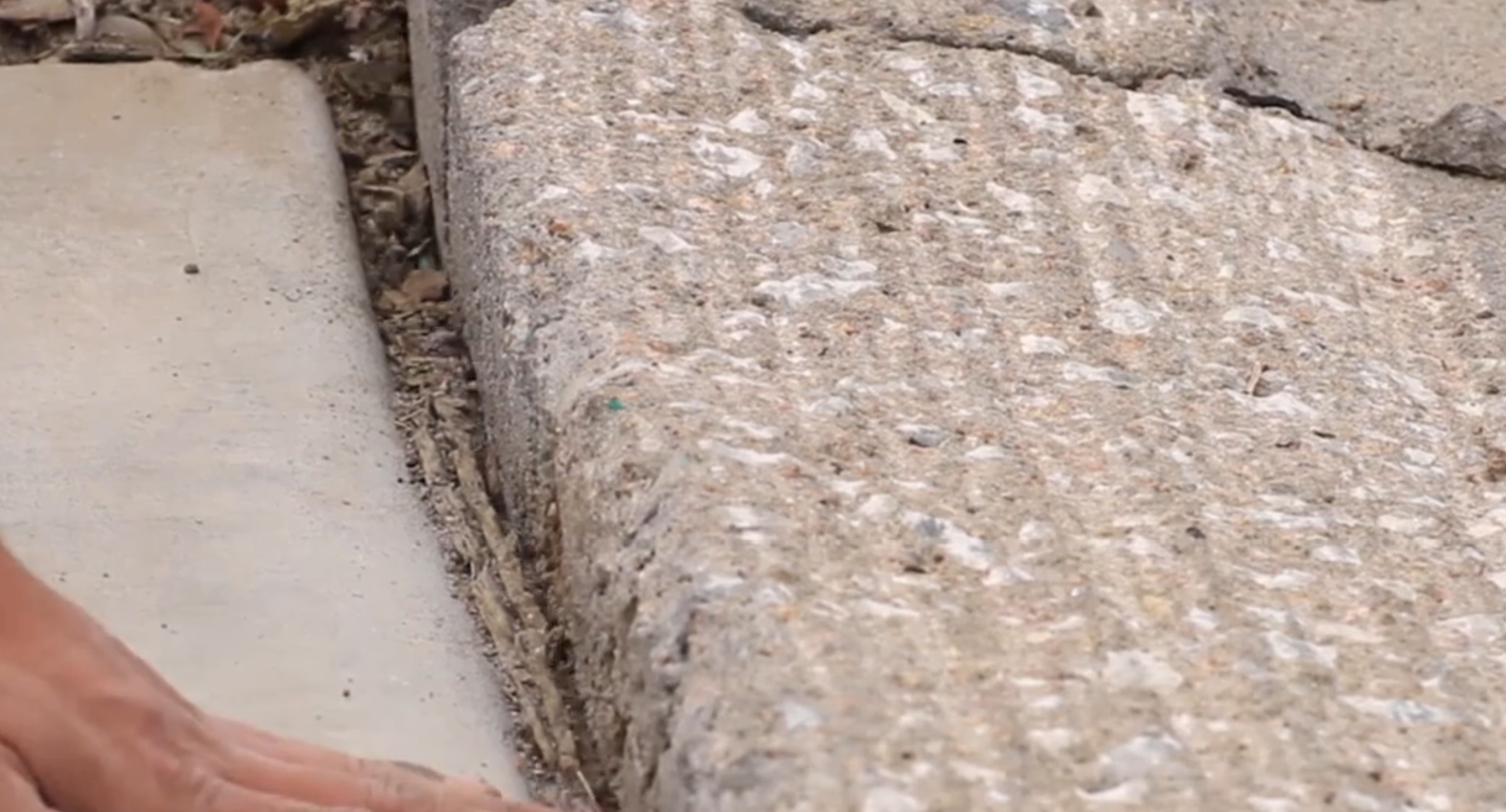 Before sidewalk repair - raised edge creating trip hazard
