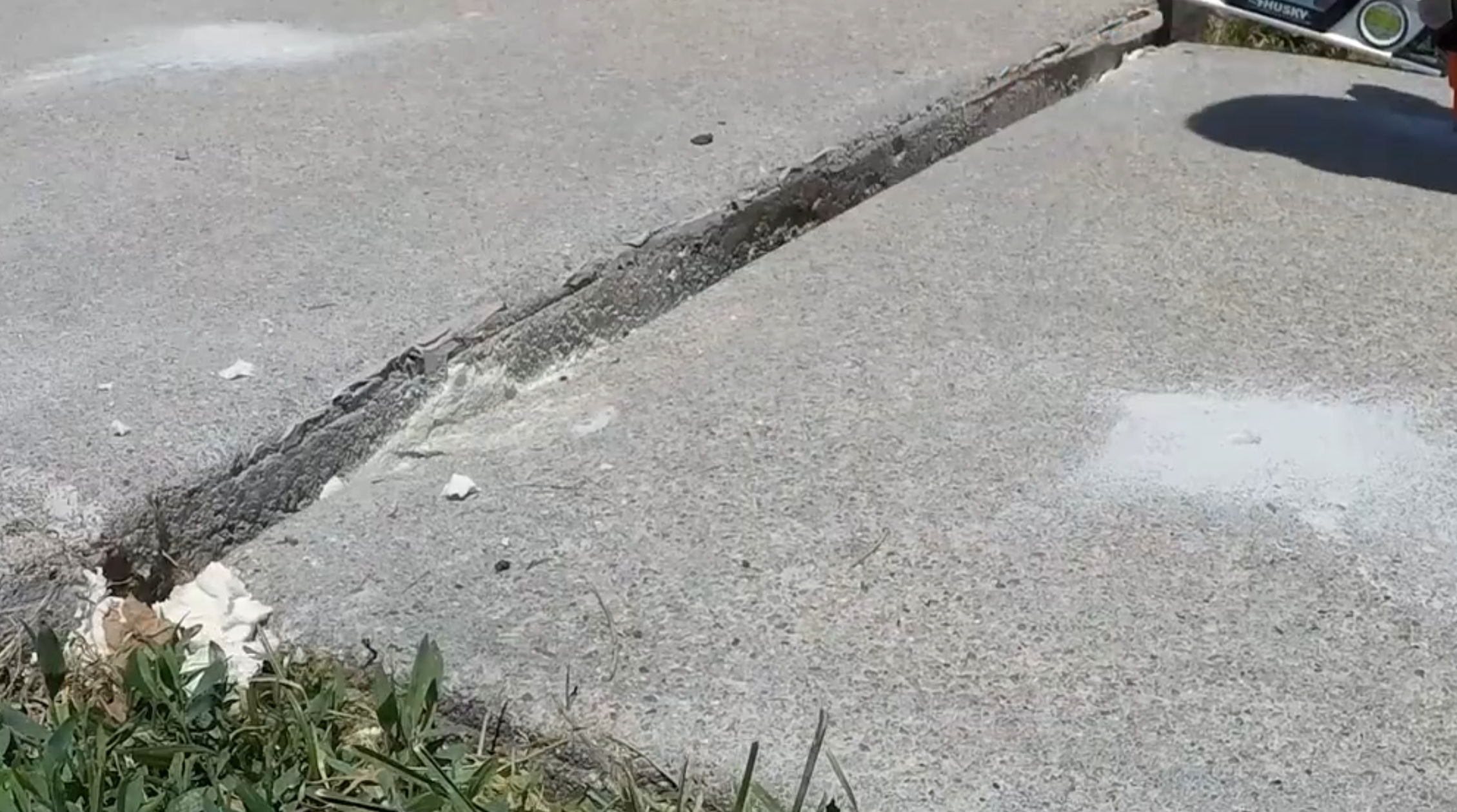 Before driveway repair - sunken and cracked concrete driveway